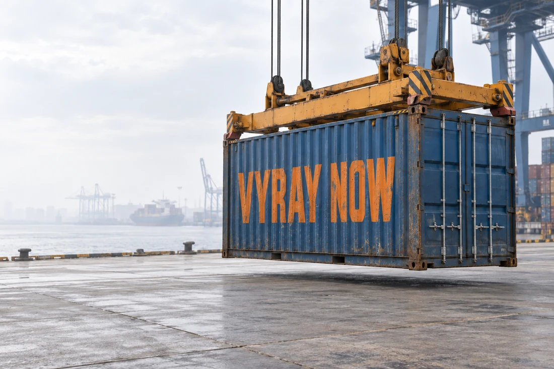 A crane lowers a blue shipping container painted VYRAY NOW onto a harbour quay.